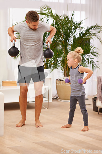 Image of Soon Ill be stronger than daddy. Full length shot of a father and daughter working out together.