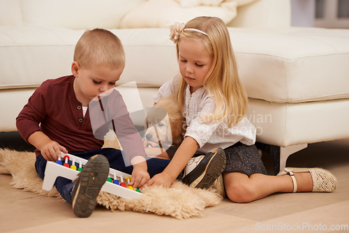 Image of There - told you i could prove string theory. Two young children playing with an abacus.