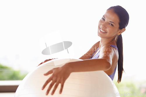 Image of Fit body, happy mind. Portrait of a beautiful young woman holding an exercise ball at home.