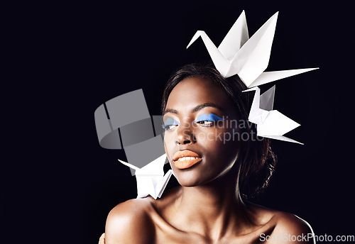 Image of Whispers of a quiet conversation. a beautiful ethnic woman posing with origami birds on her head and shoulders.