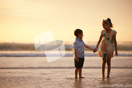 Image of Chided by the silence of a hush sublime. an adorable brother and sister bonding at the beach.