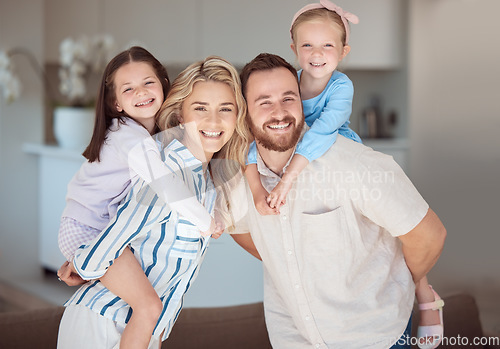 Image of Carefree caucasian family spending time together at home. Happy parents carrying their two daughters on their backs. Sisters enjoying a piggyback ride at home with mom and dad