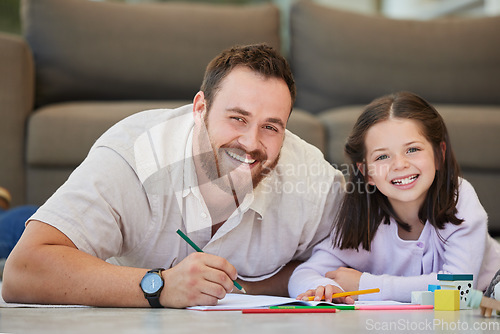 Image of Father and daughter doing homework together drawing pictures and having fun. Dad teaching daughter while using book and colouring pencils