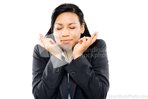 Image of Make a wish on a star. a young businesswoman crossing her fingers in hope against a studio background.