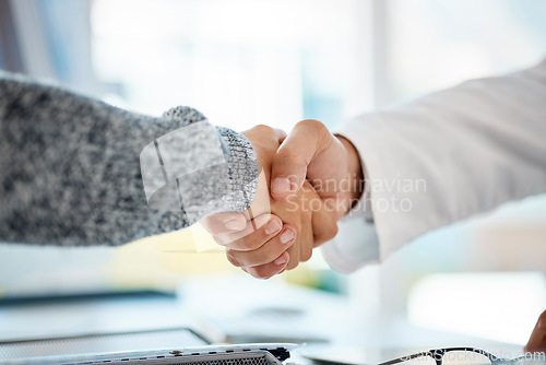 Image of Closeup of two unknown men shaking hands in a clinic after a consultation. Mixed race man thanking his doctor after a successful visit. Healthcare professional congratulating his patient in a hospita