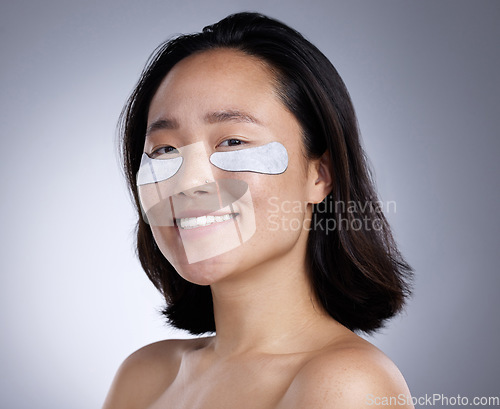 Image of Who wants puffy eyes. a young woman wearing an eye mask against a grey background.