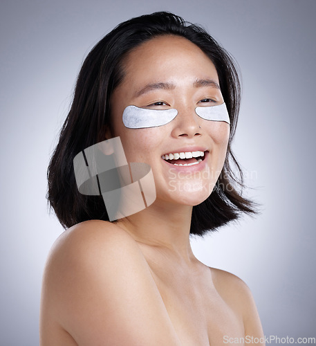 Image of Ive got my skincare routine down. a young woman wearing an eye mask against a grey background.