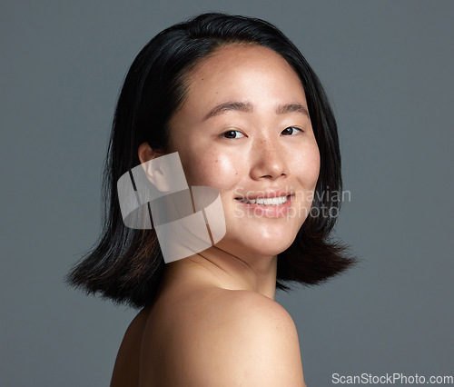 Image of Im hooked on this new skincare product. Studio shot of a beautiful young woman posing against a grey background.