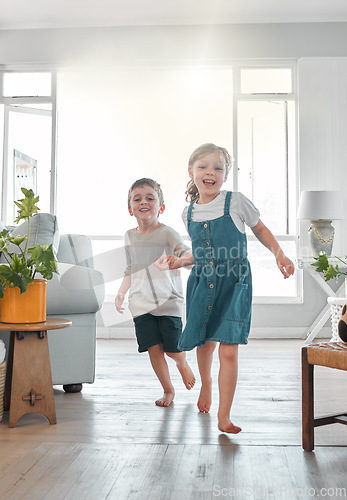 Image of Family love is forever. a brother and sister running inside the house.