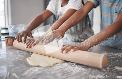 Image of Teach them while theyre young. two unrecognizable children having fun while baking in the kitchen at home.