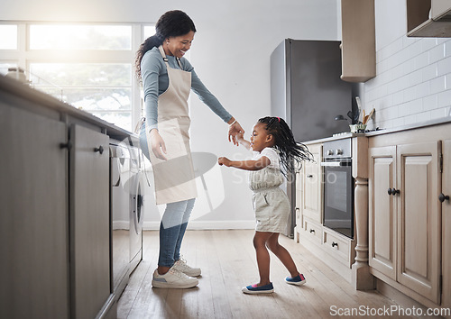 Image of I think my mom is amazing. a little girl and her mother dancing in the kitchen at home.