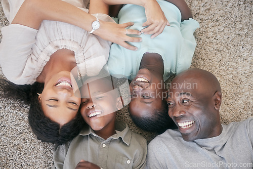 Image of The love of a family is a lifes greatest blessing. a family laying on the floor at home.