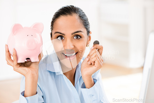 Image of Its never too early to save. a young businesswoman saving money in her piggybank.