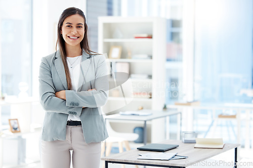 Image of Ready for the day. a young businesswoman standing in an office at work.