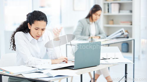 Image of Whats all of this. a young businesswoman looking overwhelmed in an office at work.