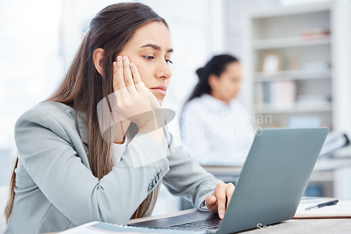 Image of Ive got nothing to do today. a young businesswoman looking bored while using a laptop in an office at work.