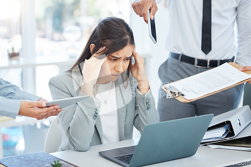 Image of Where do I start. a young businesswoman feeling overwhelmed in a demanding work environment.