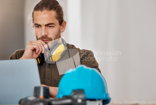 Image of Hes focused on the vision. a young businessman using a laptop in an office at work.