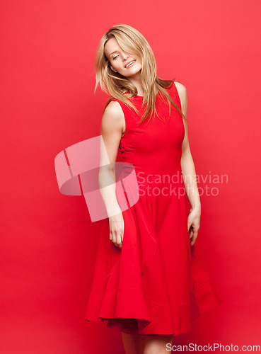 Image of Therell never be a better time than now. a beautiful young woman dancing against a red studio background.