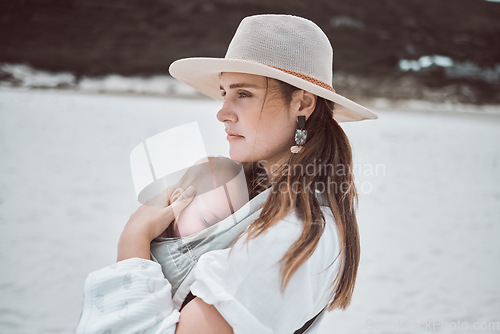 Image of Youre safe in my arms. a young mother holding her baby while at the beach.