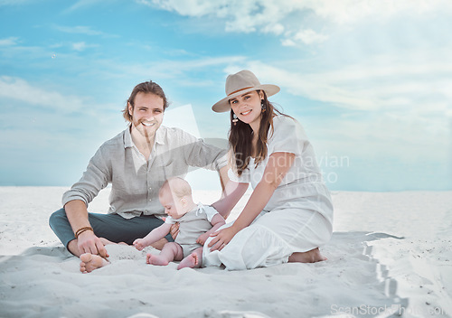Image of Babys first day at the beach. a young family spending a day at the beach.