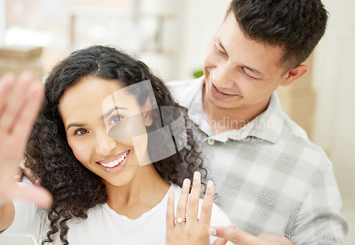 Image of She said yes. a young couple standing together and taking a selfie to celebrate their engagement.