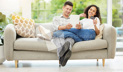 Image of Never leaving this couch. a couple using a digital tablet and credit card on the sofa at home.