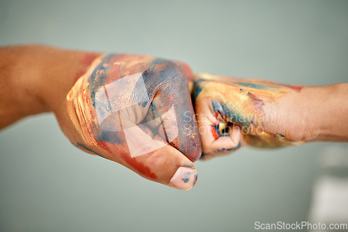 Image of Lets spread our love all over this place. an unrecognizable couple sharing a fist bump while painting.