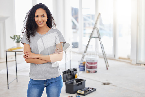 Image of This room will look a little different in a bit. a woman standing in a room under renovations.