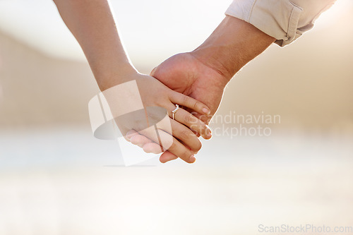 Image of We all need someone to take long walks on the beach with. Closeup shot of an unrecognizable couple holding hands on the beach.