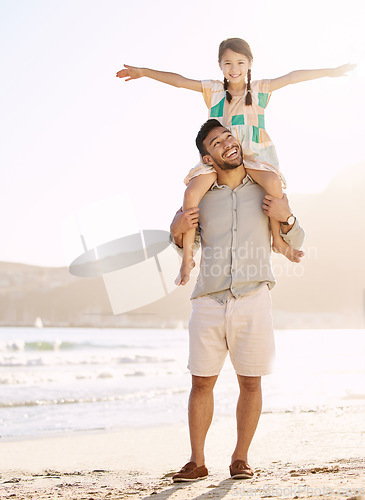 Image of Dads favourite girl. Full length shot of a handsome young man carrying his daughter on his shoulders at the beach.