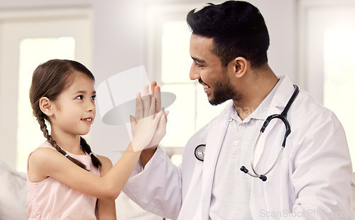 Image of Youre doing so much better than last time. a male doctor visiting a little girl at home.