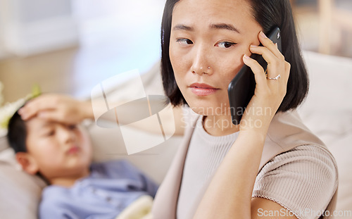 Image of Im letting the doctor know that were on our way. a woman talking on the phone after taking her childs temperature.