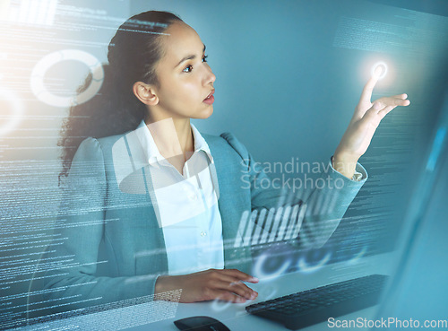 Image of All the data looks about right. an attractive young businesswoman sitting alone in the office and using a cgi screen.