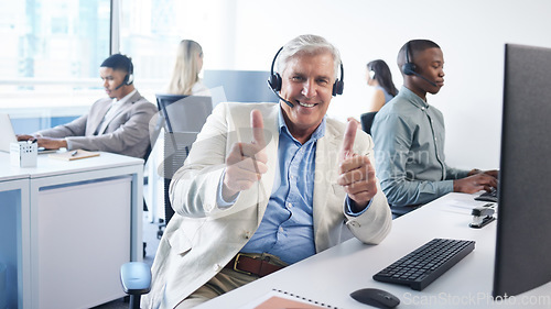 Image of With us, expect the best. a mature businessman using a headset and showing thumbs up in a modern office.