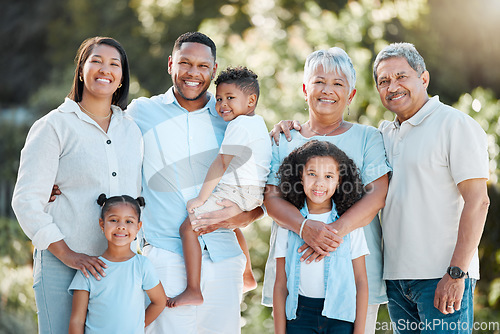 Image of Togetherness is an important ingredient of family life. a multi-generational family standing together outside.