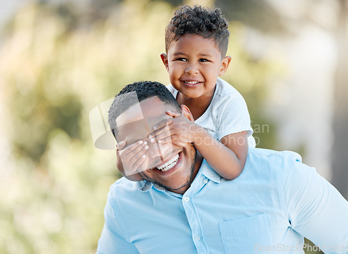 Image of The bond between a parent and child is unbreakable. a little boy covering his fathers eyes while playing outside.