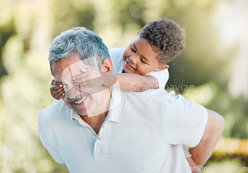 Image of I always have so much fun with my grandson. a little boy covering his grandfathers eyes while playing outside.