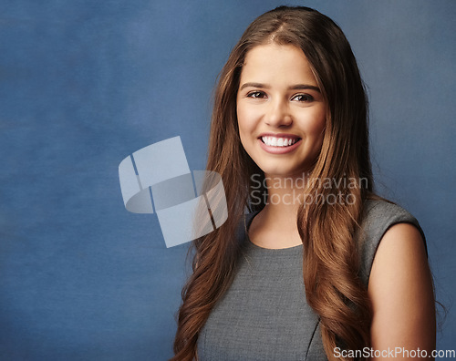 Image of Positive things happen with a positive mindset. Studio portrait of a confident young businesswoman posing against a grey background.