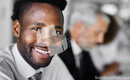 Image of The future starts today. Portrait of a businessman sitting in a boardroom meeting with colleagues blurred in the background.