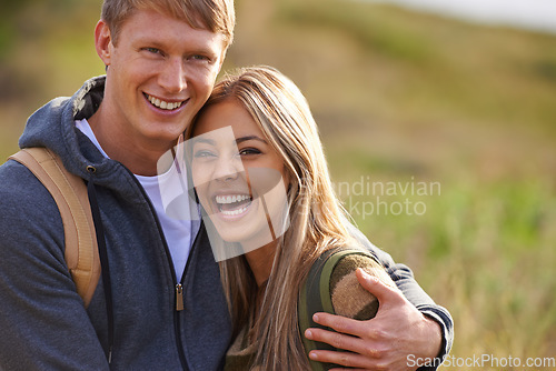 Image of Its always fun when theyre together. Portrait of a happy young couple standing on a hillside together.