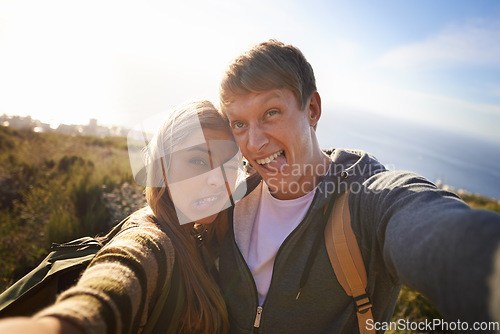 Image of Together in their weirdness. Portrait of a happy young couple making faces for the camera while out on a hike.
