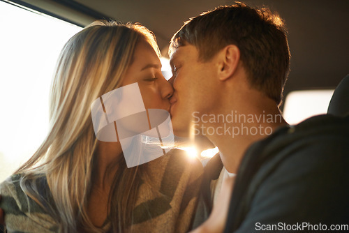 Image of Romance on the road. an affectionate young couple kissing in a car.