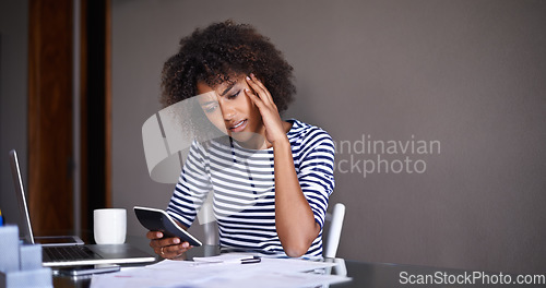 Image of Doing business from the comfort of home. an attractive young woman working at home.