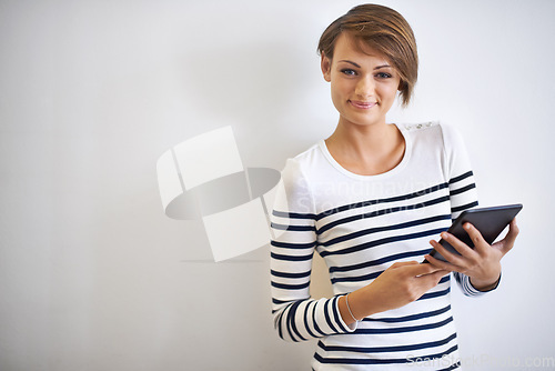 Image of Organisation made SO easy. A cropped portrait of a beautiful young woman holding a tablet.