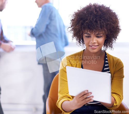 Image of Checking up on a theory. an attractive young woman looking at a digital tablet.