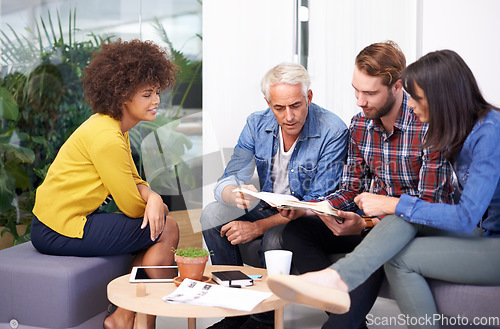 Image of Running through the ideas. a group of coworkers in a meeting.