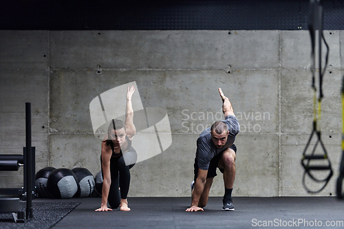 Image of A fit couple in a modern gym, engaging in running exercises and showcasing their athletic prowess with a dynamic start.