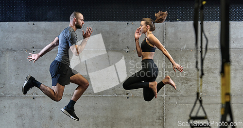 Image of A fit couple exercising various types of jumps in a modern gym, demonstrating their physical fitness, strength, and athletic performance