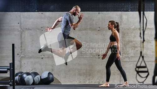 Image of A fit couple exercising various types of jumps in a modern gym, demonstrating their physical fitness, strength, and athletic performance